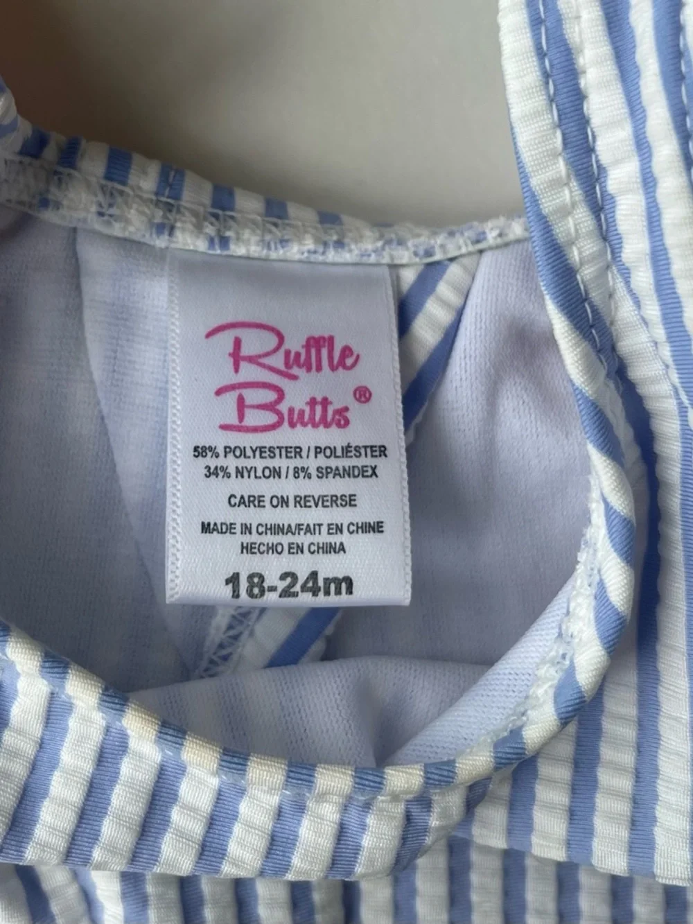 RuffleButts Blue Seersucker Two-Piece Swimsuit with Pink Polka Dot Ruffles